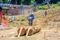 Enduro motorbike racer overcomes obstacle on off-road terrain track at motocross competition on sunny summer day