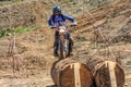 Sochi, Russia - August 16, 2014: Enduro motorbike racer overcomes obstacle on off-road terrain track at motocross competition on