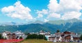 Mountain Olympic village in Krasnaya Polyana. View of the Caucasus Mountains in summer - panorama Royalty Free Stock Photo