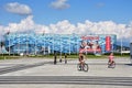 Sochi, Russia, August, 10, 2019. People on bicycles riding in front of the ice palace `Iceberg` in the summer. Sochi, Adler, Olymp