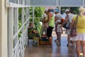 Tourists buy from an elderly woman raspberry berries on the street