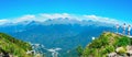 view of the Caucasus Mountains from Rosa Peak in Krasnaya Polyana in summer - panorama Royalty Free Stock Photo