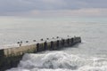 Sochi, Russia 05.07.2021. Breakwater pier summer black sea cloudy Royalty Free Stock Photo