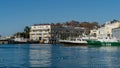 Beautiful view to boats and ships on blue surface of Black Sea by pier of Commercial seaport.