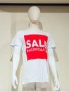 Sochi, Russia - 14 December 2019. White abstract mannequin in white t-shirt with white inscription SALE in a red square