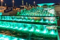Illuminated waterfall fountain cascade by Olympic Park enchants with its beautiful play of