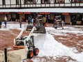 Sochi, Russia - 25 February 2020. A tractor clears snow raking it in a heap in a ski resort area