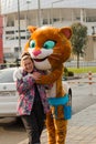 Sochi, Russia - January, 2017:Leopard, Symbol of the Winter Olympic Games hugs a young girl