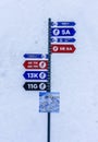 Sochi, Russia - January 7, 2018: Pole with colorful information arrows pointing directions to ski trails of different complexity i