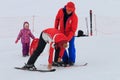 Sochi, Russia - January, 2017: Ski Instructor teaches young girl to stand on skis