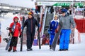 Family of four male people carrying ski and snowboard equipment walked out for a ski ride