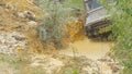 Sochi, Russia 5 June: Car wheel on a dirt road. Off-road tire covered with mud, dirt terrain. Outdoor, adventures and