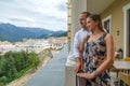 Young happy Caucasian couple enjoying together a scenic summer mountain view standing on restaurant`s terrace of former Solis Royalty Free Stock Photo