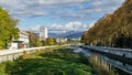 Beautiful autumn view of Sochi river, embankment with trees and snowy peaks of the Main Caucasian ridge. Sochi city center