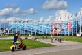 Sochi, Russia, August, 10, 2019. People on bicycles riding in front of the ice palace `Iceberg` in the summer. Sochi, Adler, Olymp