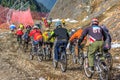 Sportsmen mountain bikers ride bikes while racing down ski track in Caucasus mountains