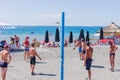 Sochi, Russia - September 07, 2019: Young people playing volleyball on the beach. Team sport and activity on vacation Royalty Free Stock Photo