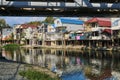 The bank of the Dagomys river is built up with small cottages with garages for boats