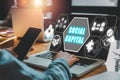 Business woman working on laptop computer on desk with social capital icon on virtual screen