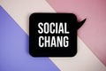 Social Change text on speech bubble top view on purple geometric background Royalty Free Stock Photo