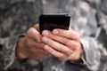 Social Cyber Warfare. Army Soldier Using Phone