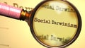 Social darwinism and a magnifying glass on word Social darwinism to symbolize studying and searching for answers related to a