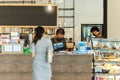 Social distance conceptual small business waiter serving customer in cafe. Royalty Free Stock Photo