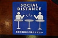 Social Distance word sticker on the table