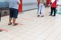 Social distancing being practiced at entrance to supermarket, with 1 meter gap between people in queue