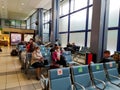 Social distancing concept, airport seats warning signs due to coronavirus. People in medical masks. Novosibirsk, September 22,