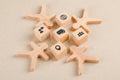 Social distancing concept with icons on wooden cubes, wooden figures on paper background high angle view