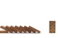 Wood domino toys on white background, . Domino effect. 8 dominos is falling and next one nomino can Royalty Free Stock Photo