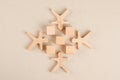 Social distancing concept with wooden cubes and human figures on paper background flat lay