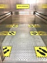 Social distancing for COVID-19 coronavirus crisis prevention with yellow footprint sign with text caution respect social distance