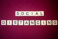 The words `SOCIAL DISTANCING` in letter tile