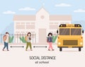 Social distancing at school after pandemia. Back to school concept after epidemic. Kids quing to pick up by bus wearing Royalty Free Stock Photo