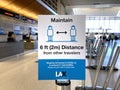 Social Distancing sign in LAX international airport requesting travelers to practice social distance of 6 feet or 2 meters