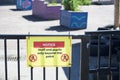 Social distancing sign at school playground road crossing