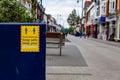 Social distancing sign in a town centre reminding people that the virus is still dangerous and to take precautions and be safe Royalty Free Stock Photo