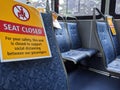 Social distancing signs on seats inside King County public transit buses