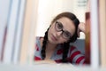 Social distancing student concept, education at home. High school girl doing homework at home in private library. The school is Royalty Free Stock Photo