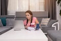 Social distancing student concept, education at home. High school girl doing homework at home with laptop. Teen study home the