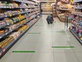 Social distancing tape lines across a supermarket floor