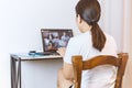 Social distancing woman during group video call with friends.