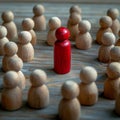 Social dynamics red wooden doll surrounded, conveying discussions or leadership