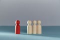 Social exclusion. Bullying, court of lynching. Loneliness and isolation. Wooden figures and one red person stands alone