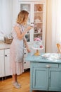 Social housewife texing, taking picture of sweet cake she baked