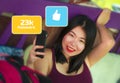 Social media addiction - young beautiful and relaxed Asian student girl using internet app networking with hand phone obsessed Royalty Free Stock Photo