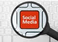 Social media button under the magnifying glass Royalty Free Stock Photo