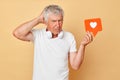 Social media communication. Blogger\'s digital content. Clicking the heart icon. Confused gray haired mature man pensione Royalty Free Stock Photo